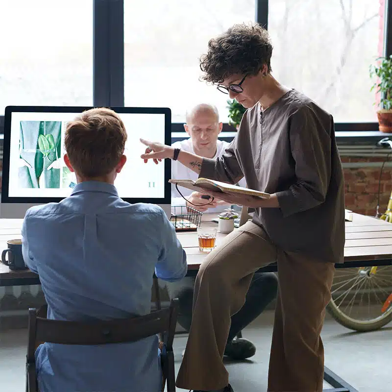 Office workers at a desk and computer